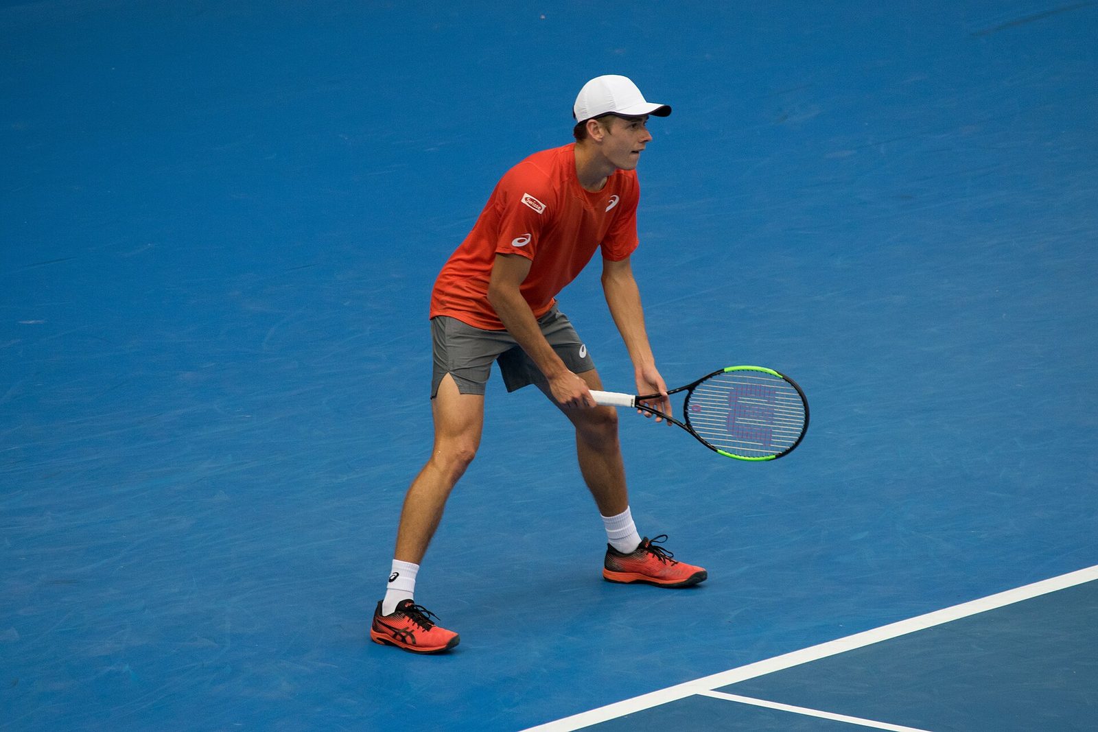 Alex de Minaur waiting to return serve at the Australian Open