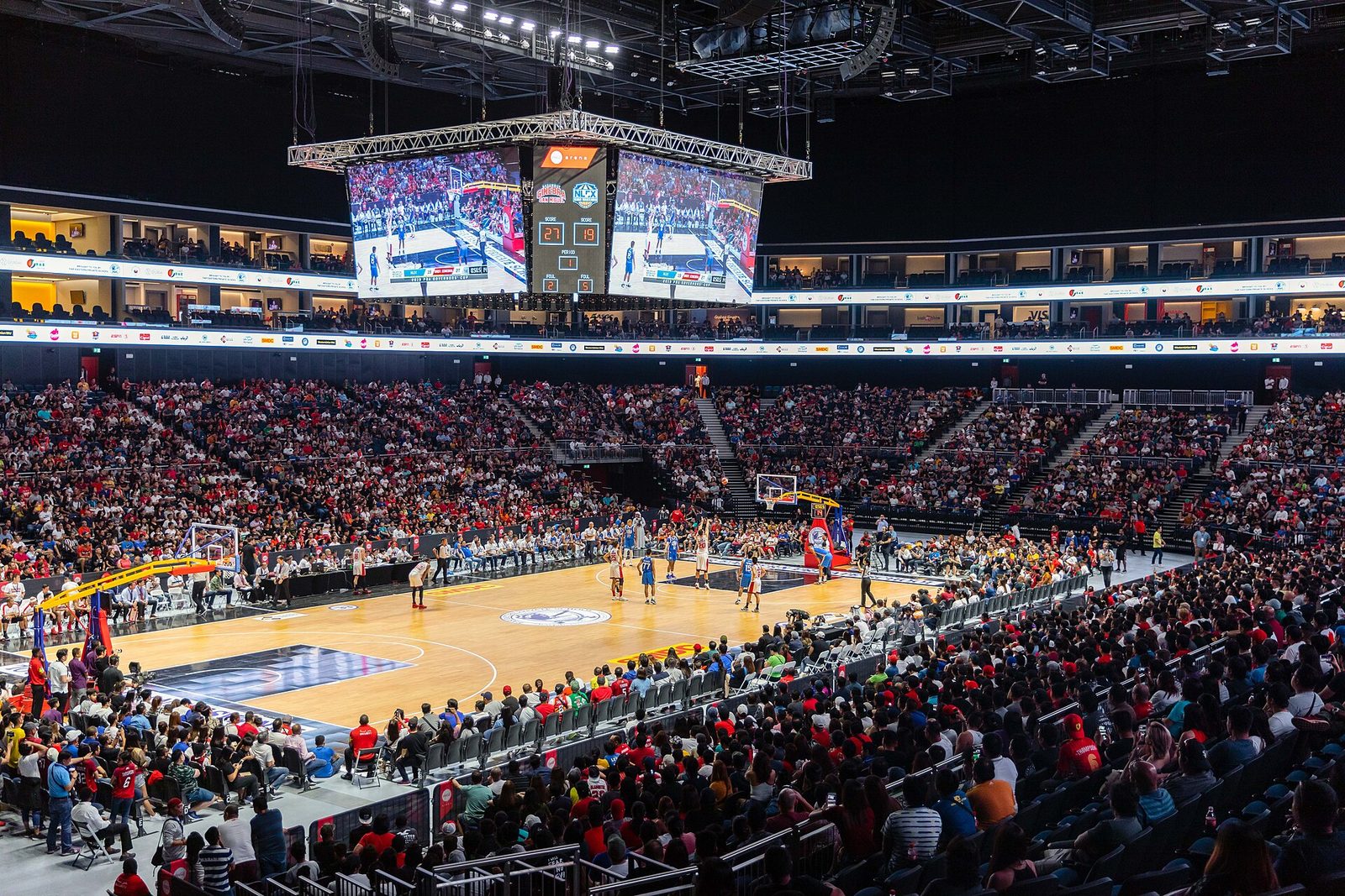 Inside Coca-Cola Arena in Dubai during a basketball game, with a packed crowd