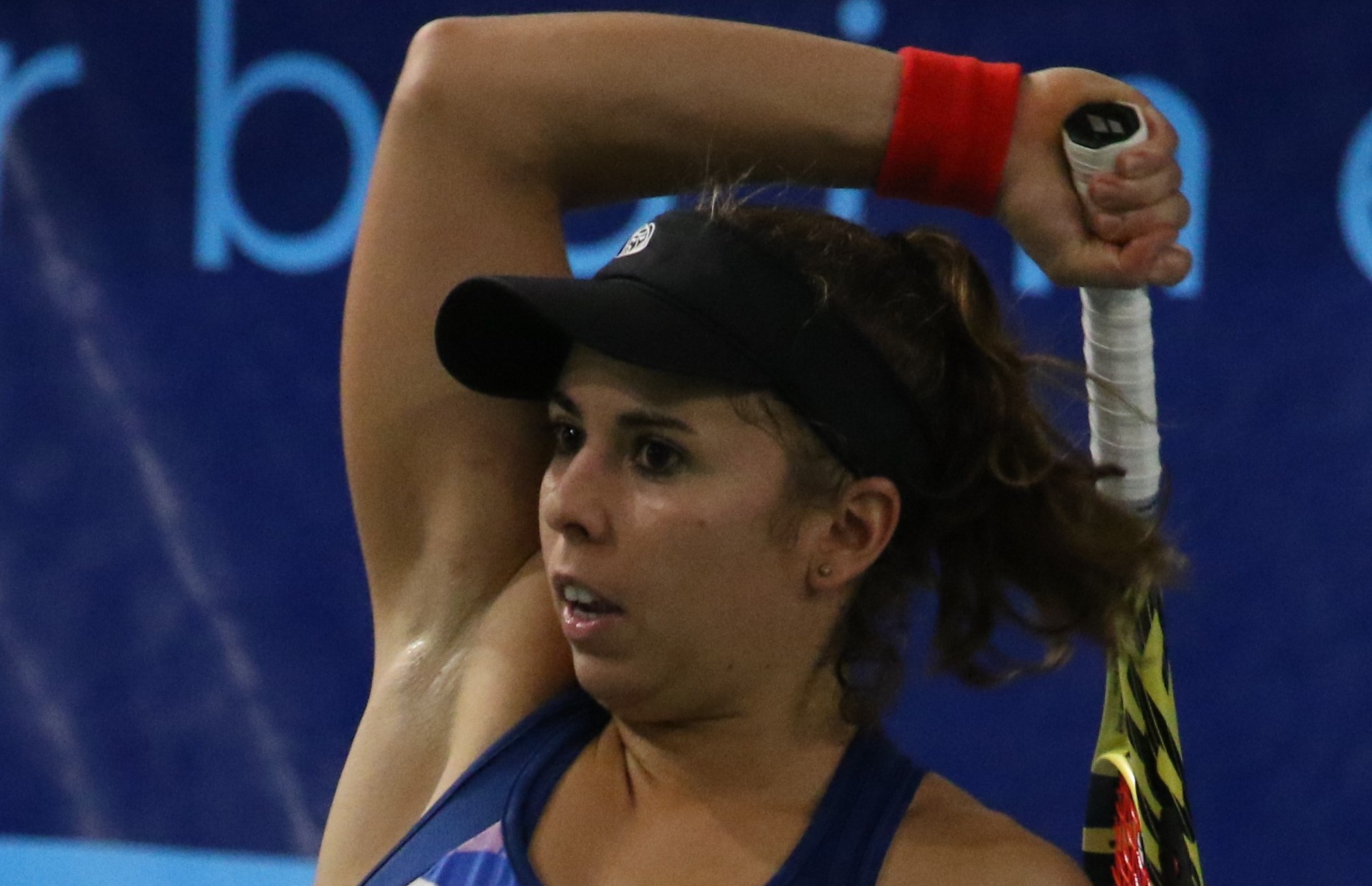 Julia Grabher hitting a backhand on an indoor hard court in Poitiers