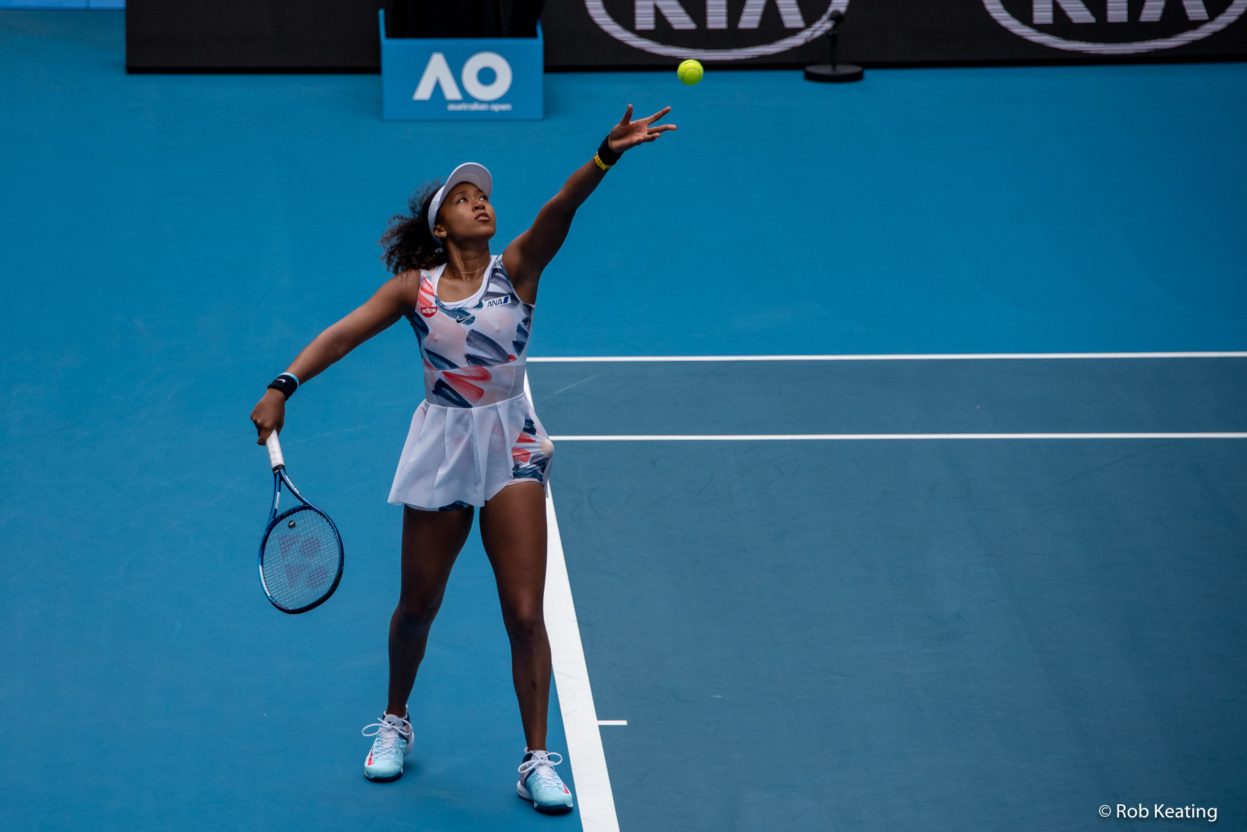 Naomi Osaka serving on a hard court at the Australian Open
